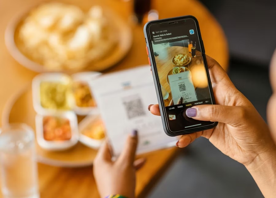 Guest scanning a QR code at a restaurant table